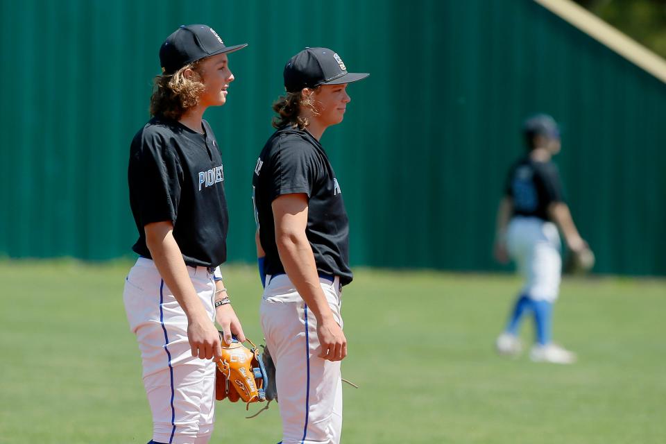 Ethan Holliday, left, and Jackson Holliday stand during a Stillwater High School baseball game in Stillwater, Okla., Saturday, April 30, 2022.