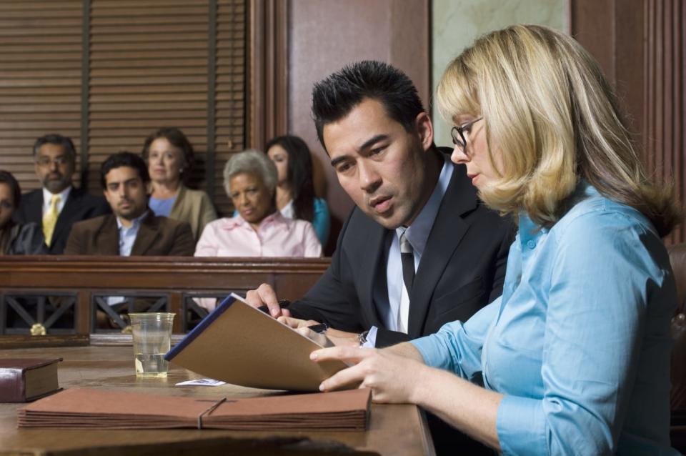 Lawyer defending client with jury in court