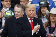 President Donald Trump, accompanied by U.S. Trade Representative Robert Lighthizer, second from left, moves to sign a new North American trade agreement with Canada and Mexico, during an event at the White House, Wednesday, Jan. 29, 2020, in Washington. (AP Photo/Alex Brandon)