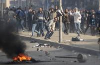 Supporters of Muslim Brotherhood and ousted Egyptian President Mohamed Mursi clash with riot police during clashes at Nasr City district in Cairo, January 3, 2014. (REUTERS/Mohamed Abd El Ghany)