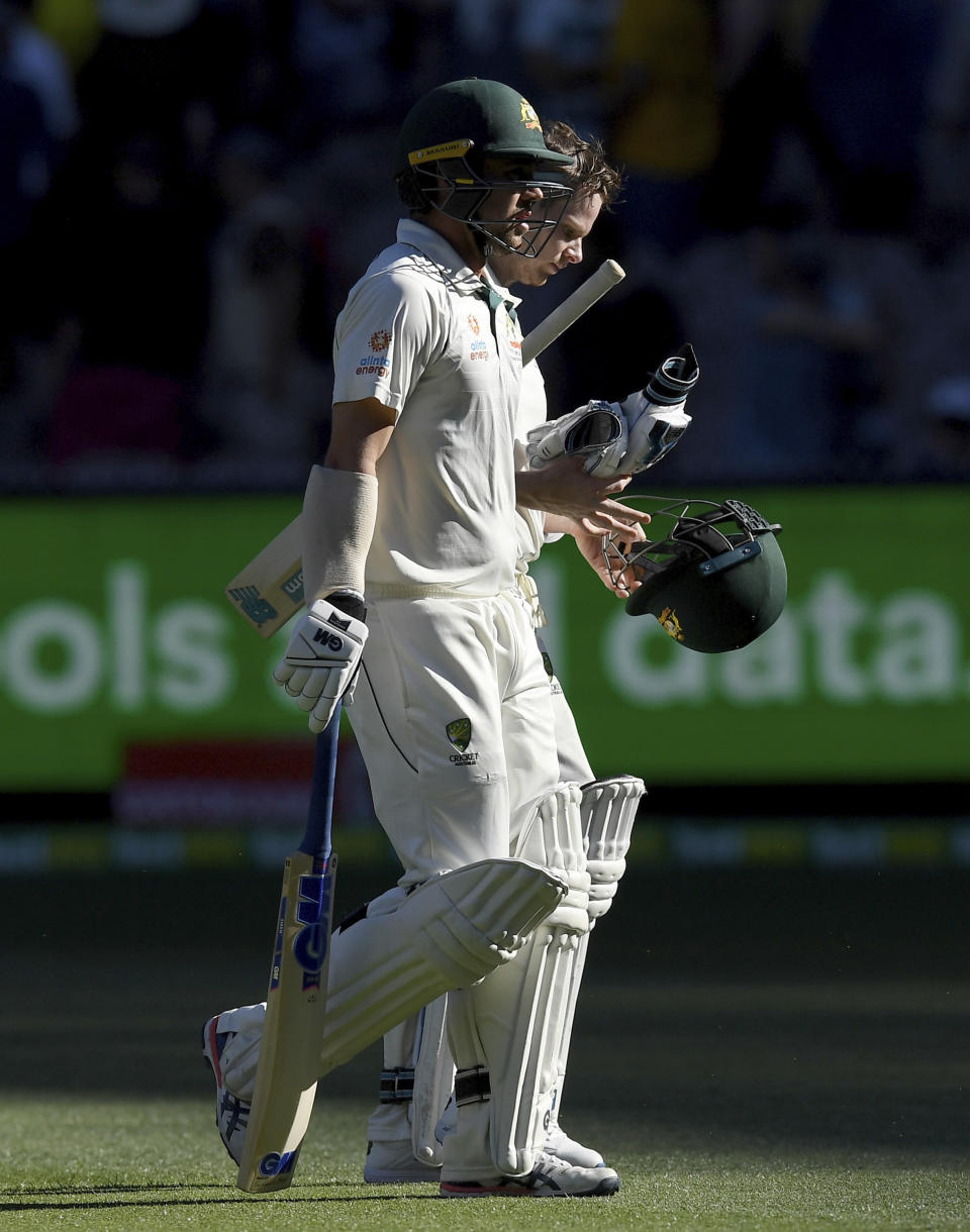 Australia's Travis Head, left, and Australia's Steven Smith leave the field at the end of play against New Zealand play in their cricket test match in Melbourne, Australia, Thursday, Dec. 26, 2019. (AP Photo/Andy Brownbill)