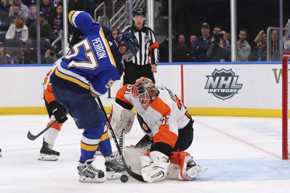 Philadelphia Flyers goalie Brian Elliott (37) makes a save against St. Louis Blues forward David Perron (57) during the second period of an NHL hockey game Wednesday, Jan. 15, 2020 in St. Louis. (AP Photo/Dilip Vishwanat)