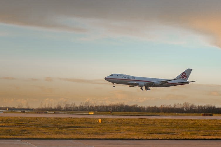 A civil aeroplane landing on a runway.