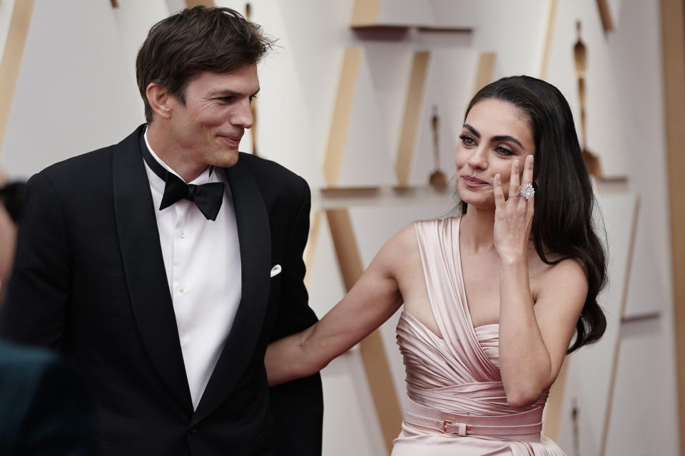 FILE - Ashton Kutcher, left, and Mila Kunis arrive at the Oscars on March 27, 2022, at the Dolby Theatre in Los Angeles. The couple are apologizing for character letters they wrote on behalf of fellow “That ’70s Show” actor Danny Masterson before he was sentenced for rape this week. (AP Photo/Jae C. Hong, File)