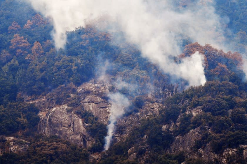 Smoke rises from an area adjacent to Moro Rock during a tour of the KNP Complex fire burn area in Sequoia National Park