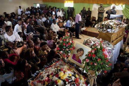 Mourners gather at a funeral service for bomb attack victims Pastor Peter Mutabazi and Becky Tendo at Bwaise Penecostal Church on the outskirts of the capital Kampala July 13, 2010. REUTERS/Benedicte Desrus