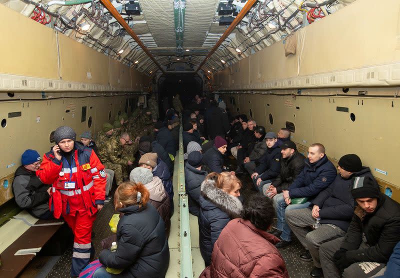 Ukrainian citizens who were exchanged during a prisoners of war swap are seen inside an aircraft near Kharkiv