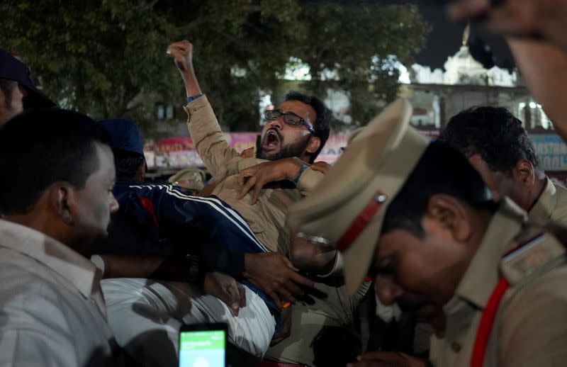 A demonstrator reacts as he is detained by police during a flash protest against a new citizenship law, in Hyderabad