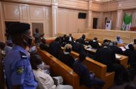 A police member stands guard as lawyers sit for an appeal hearing about a blasphemy conviction, in northern Nigeria's Kano state