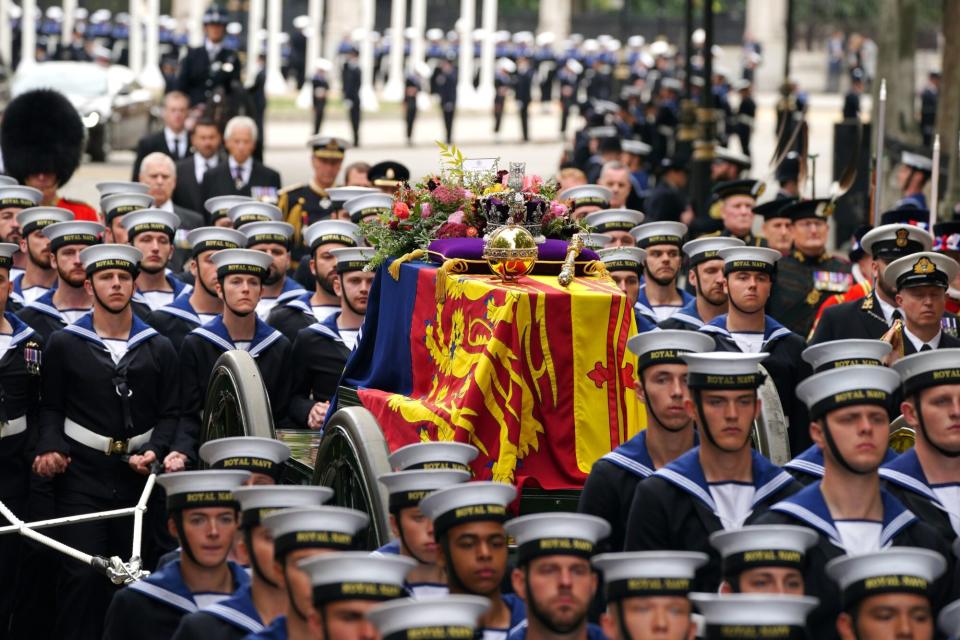 The State Gun Carriage carries the coffin of Queen Elizabeth II, draped in the Royal Standard with the Imperial State Crown and the Sovereign's orb and sceptre, in the Ceremonial Procession during her State Funeral at Westminster Abbey, London. Picture date: Monday September 19, 2022. (Photo by Peter Byrne/PA Images via Getty Images)