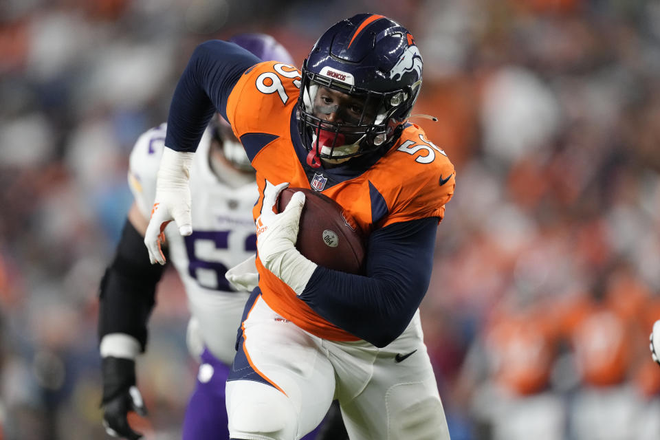 Denver Broncos linebacker Baron Browning (56) runs a fumble in for a touchdown against the Minnesota Vikings during the first half of an NFL preseason football game, Saturday, Aug. 27, 2022, in Denver. (AP Photo/David Zalubowski)