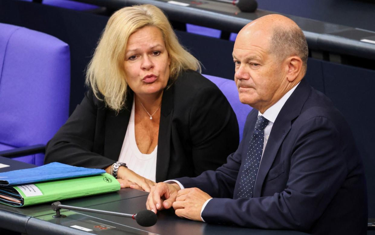 Nancy Faeser, the German interior minister, with Olaf Scholz, the chancellor in the Bundestag