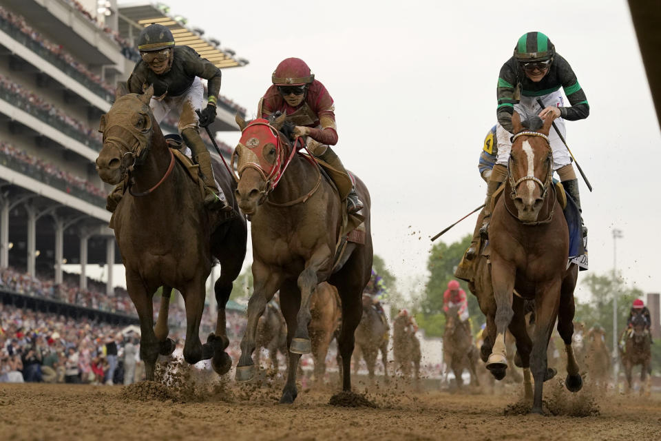 Brian Hernandez Jr. rides Mystik Dan, right, to the finish line to win the 150th running of the Kentucky Derby horse race at Churchill Downs Saturday, May 4, 2024, in Louisville, Ky. (AP Photo/Jeff Roberson)