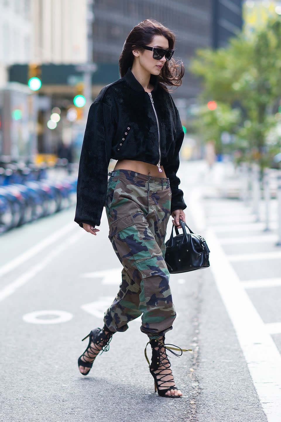 <p>In camo pants, corduroy bomber, lace-up heeled sandals, a black leather satchel and rectangular sunnies leaving the Victoria's Secret offices—after <a href="https://www.harpersbazaar.com/fashion/models/news/a18406/bella-hadid-victorias-secret-fashion-show/" rel="nofollow noopener" target="_blank" data-ylk="slk:landing a coveted spot;elm:context_link;itc:0;sec:content-canvas" class="link ">landing a coveted spot</a> in this year's fashion show. </p>