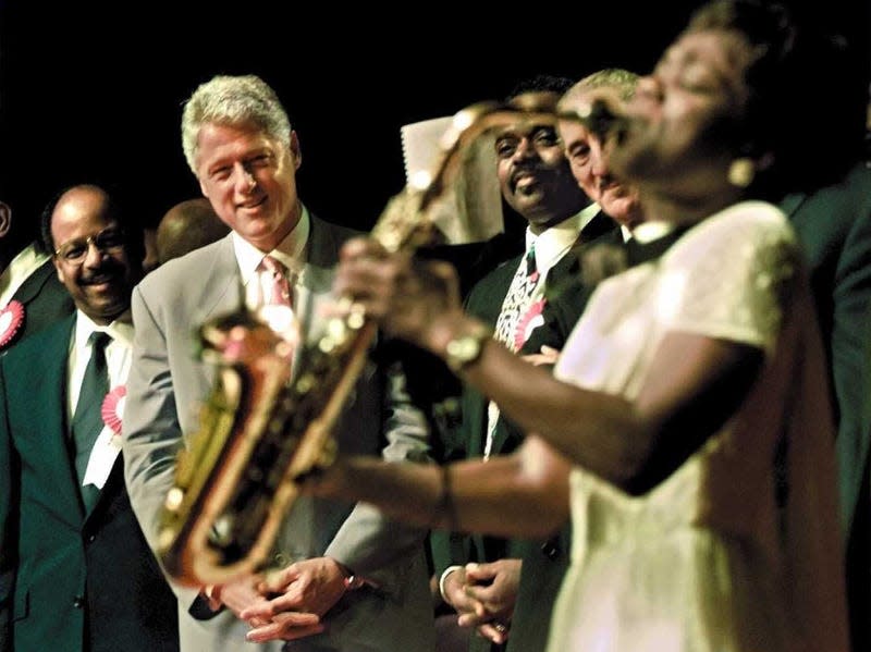 ORLANDO, UNITED STATES: US President Bill Clinton (C) , Reverend Henry Lyons(L), and Reverend Roscoe Cooper(3rd L) watch church member Angella Christi play a solo on her saxaphone 06 September during the National Baptist Convention in Orlando, Florida. The President is on a two-day campaign swing in Florida. (ELECTRONIC IMAGE) AFP PHOTO by Paul RICHARDS - Photo: PAUL J. RICHARDS/AFP (Getty Images)