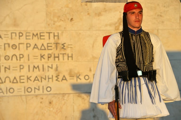 A Greek presidental Evzoni guard stands to attention in front of the Greek parliament in central Athens