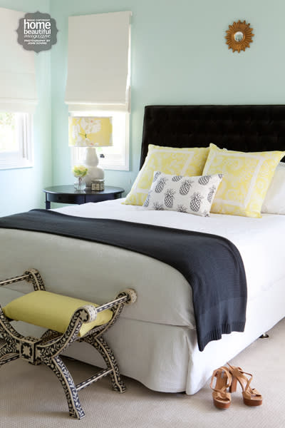 This room executes sunny yellow in a harmonious way by using accessories which pop against the black.