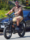 <p>Adam Sandler enjoys an afternoon bike ride around Malibu on Sunday.</p>