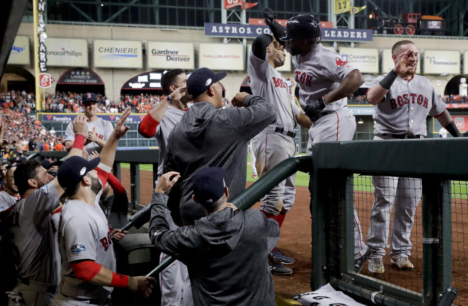 Boston Red Sox's Jackie Bradley Jr. celebrates in the dugout after his grand slam against the Houston Astros during the eighth inning in Game 3 of a baseball American League Championship Series on Tuesday, Oct. 16, 2018, in Houston. (AP Photo/David J. Phillip)