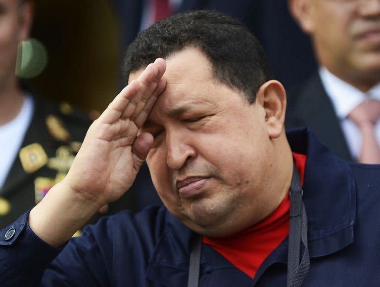 Venezuelan President Hugo Chavez salutes during a ceremony at Caracas' Miraflores Palace, on June 2, 2012. With Chavez ailing and absent, Venezuela's leftist government launches a new presidential term with a display of popular support on the day he was to be inaugurated