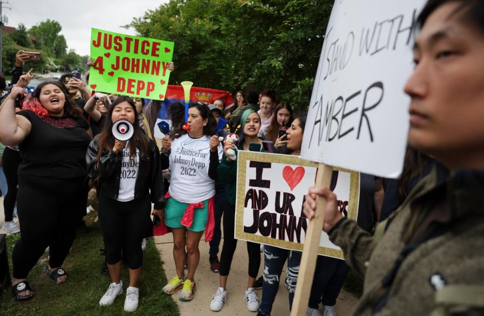 Supporters standing outside the US trial in Fairfax, Virginia, in May 2022 (Getty)