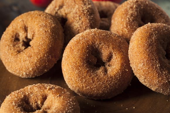 a pile of brown sugar donuts on a table