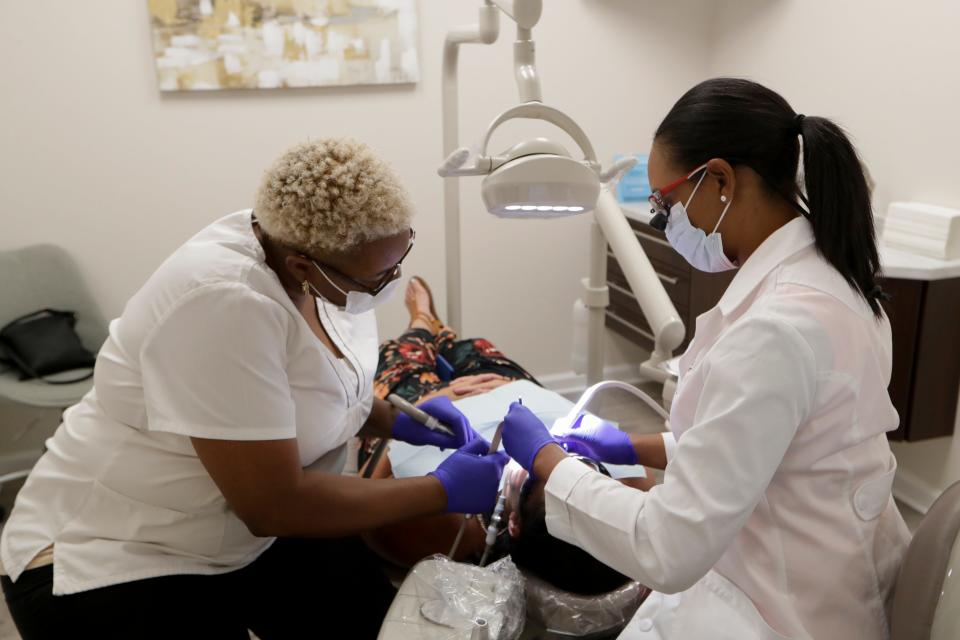 Dr. Chinara Garraway, left, and Dental Assistant Carol Brown, work on a patient at Blissful Dental Spa Monday, August 5, 2019. 