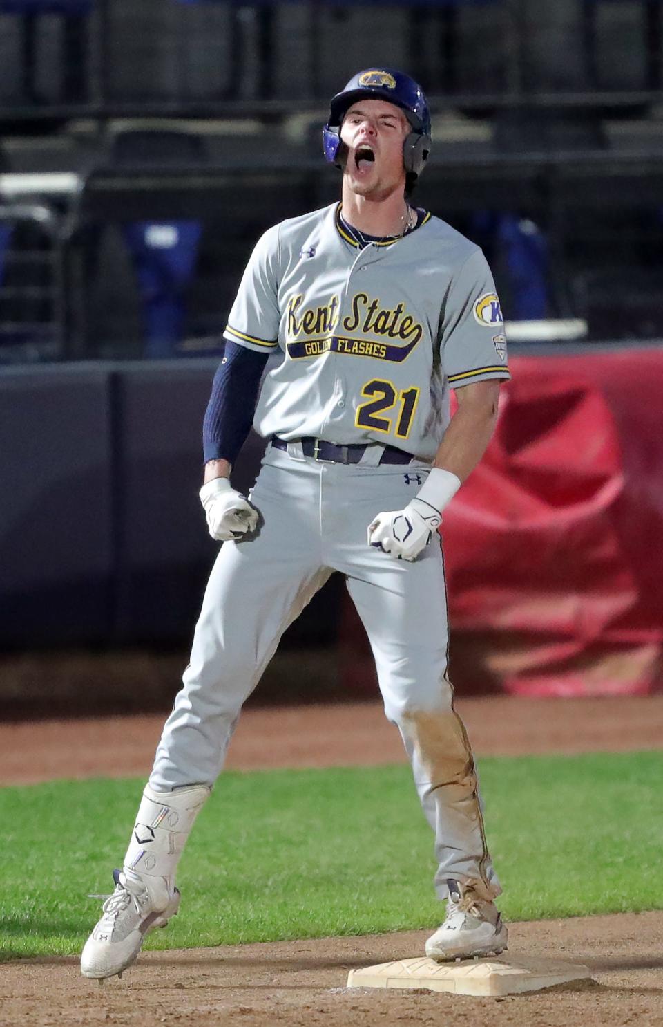 Kent State right fielder Jake Casey (21) celebrates after hitting a RBI triple against the Akron Zips during the eighth inning of an NCAA baseball game at Canal Park, Tuesday, May 9, 2023, in Akron, Ohio.