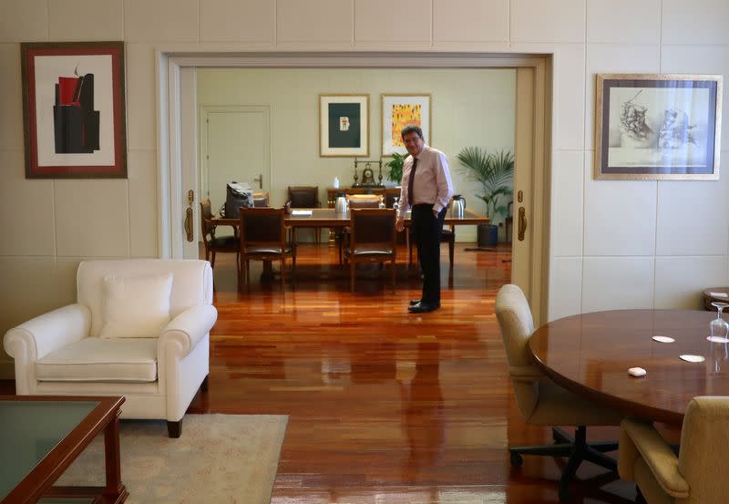 Spain's Social Security Minister, Escriva, stands in his office during an interview with Reuters at his ministry in Madrid