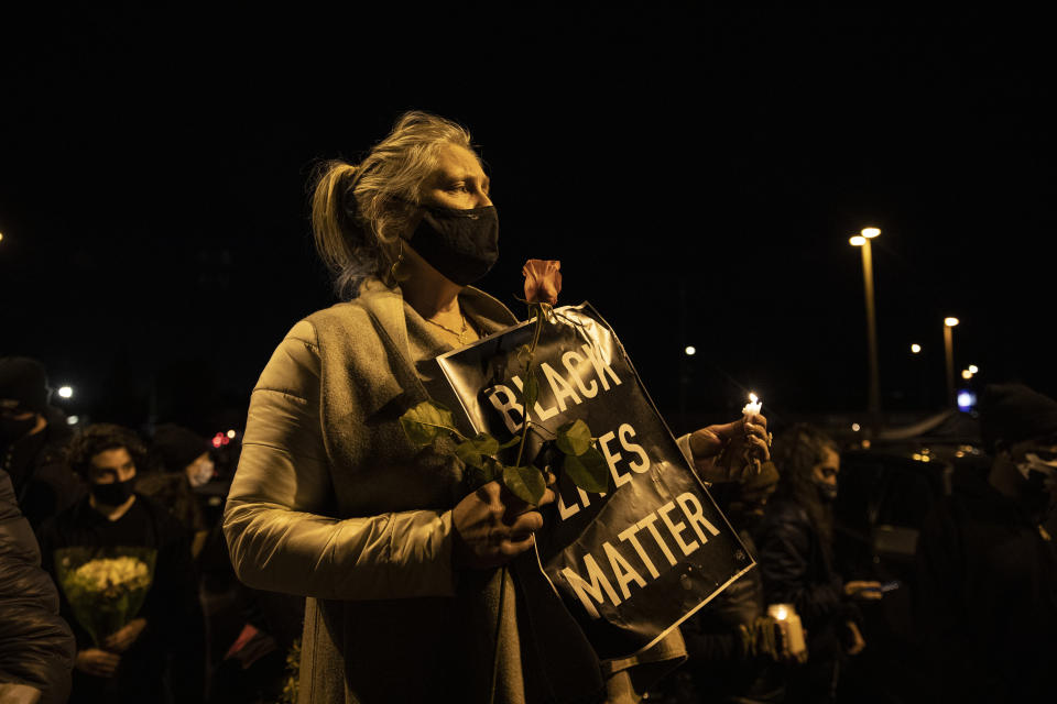 People gather for Kevin Peterson Jr., who was killed in Thursday's shooting with police involved, at a candlelight vigil in Vancouver, Wash., Friday, Oct. 30, 2020. The Clark County Sheriff's office has not released any details on the Thursday evening shooting in Hazel Dell, but a man told The Oregonian/OregonLive that his 21-year-old son was fatally shot by police. (AP Photo/Paula Bronstein)