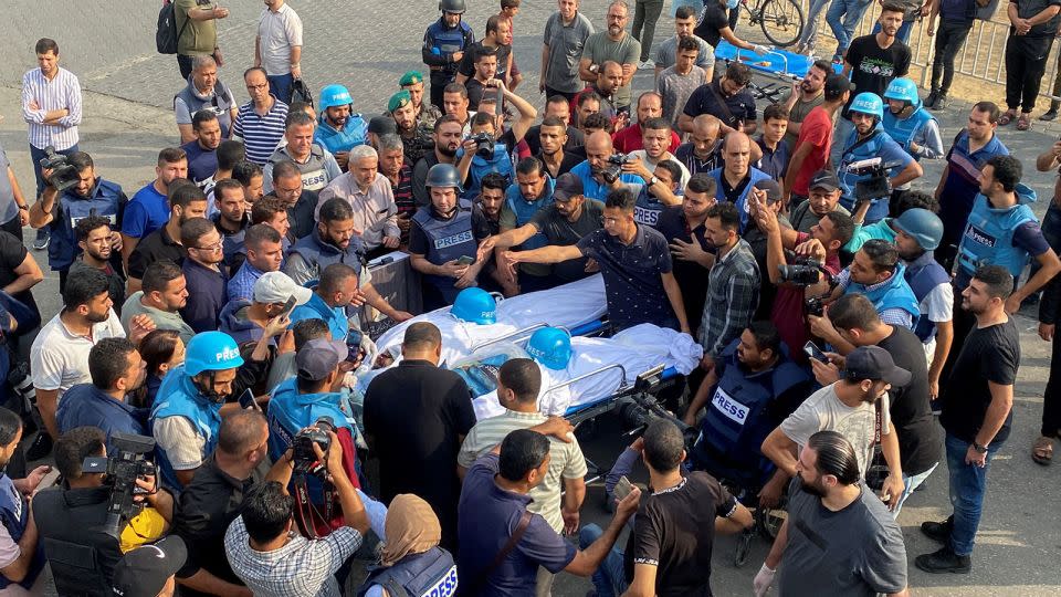 Mourners carry the bodies of Palestinian journalists Mohammed Soboh and Saeed Al-Taweel, killed when an Israeli missile hit a building while they were reporting, in Gaza City, on October 10. - Arafat Barbakh/Reuters