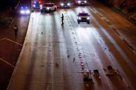 Washington State Troopers investigate the scene where two people in a group of protesters were struck by a car on Interstate 5, in Seattle