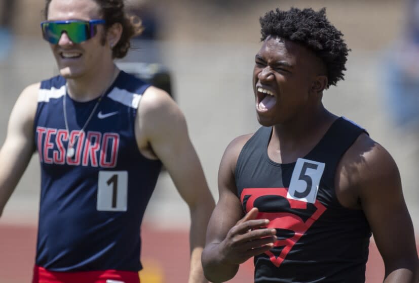 Moorpark, CA - May 21: Rodrick Pleasant of Gardena Serra High, right, yells after winning the 100 meters and a state record in 10.14 seconds at the Southern Section Masters Meet at Moorpark High School on Saturday, May 21, 2022 in Moorpark, CA. (Brian van der Brug / Los Angeles Times)