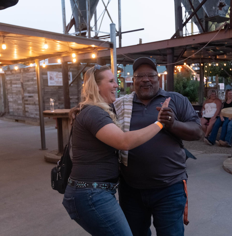 A dance is shared with smiles Saturday evening at the 1st annual Calf Fry Festival at the Starlight Ranch Event Center in Amarillo.