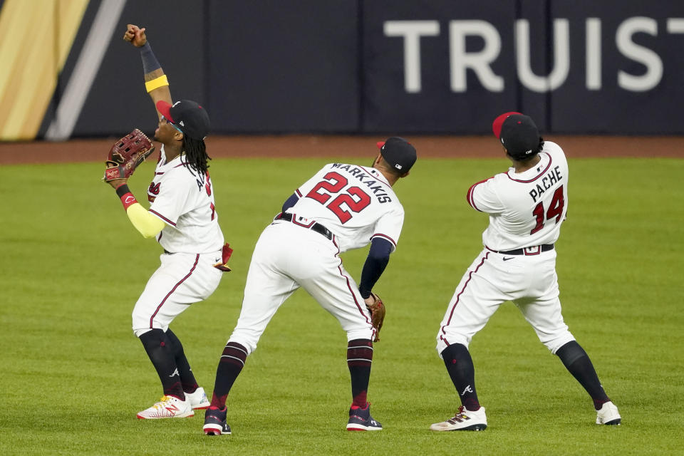 Atlanta Braves center fielder Ronald Acuna Jr., from left, right fielder Nick Markakis and center fielder Cristian Pache celebrate their win against the Los Angeles Dodgers in Game 4 of a baseball National League Championship Series Thursday, Oct. 15, 2020, in Arlington, Texas. (AP Photo/Tony Gutierrez)