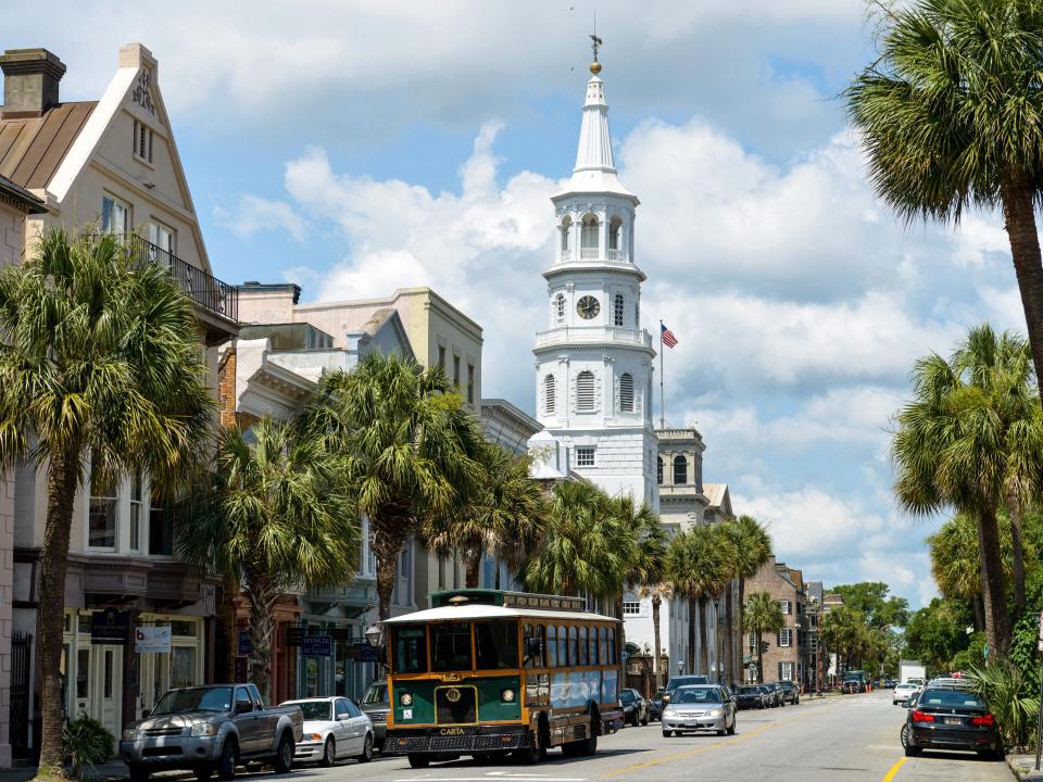 A Charleston DASH trolley, part of the CARTA Transit System, driving on the historic Broad street in Downtown Charleston.