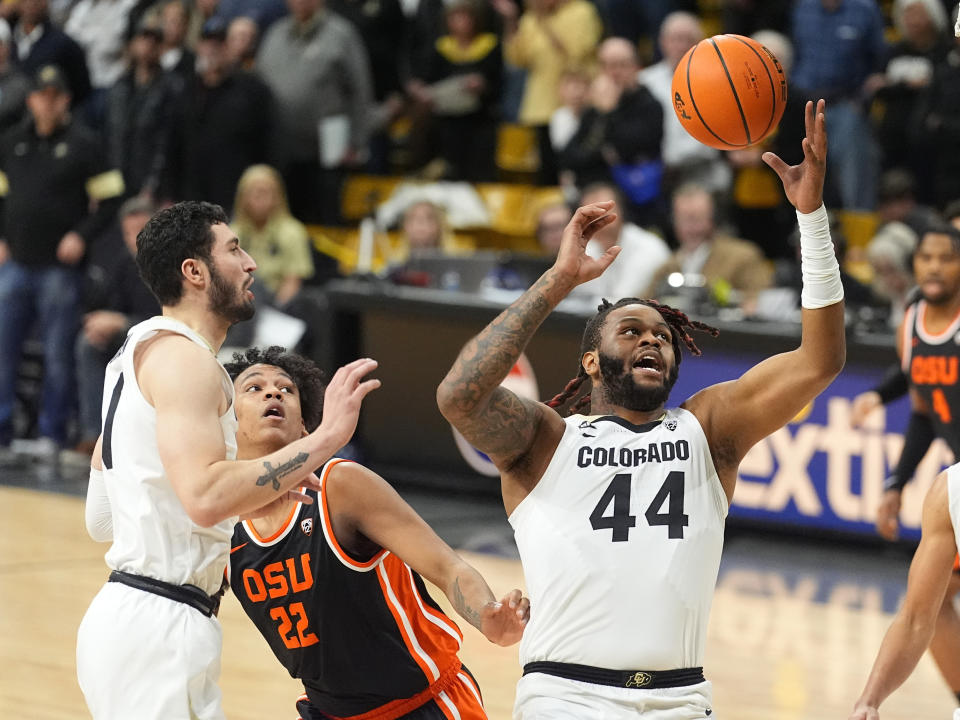 Colorado center Eddie Lampkin Jr. (44) pulls in a rebound as Colorado guard Luke O'Brien, left, and Oregon State forward Thomas Ndong (22) watch in the first half of an NCAA college basketball game Saturday, Jan. 20, 2024, in Boulder, Colo. (AP Photo/David Zalubowski)