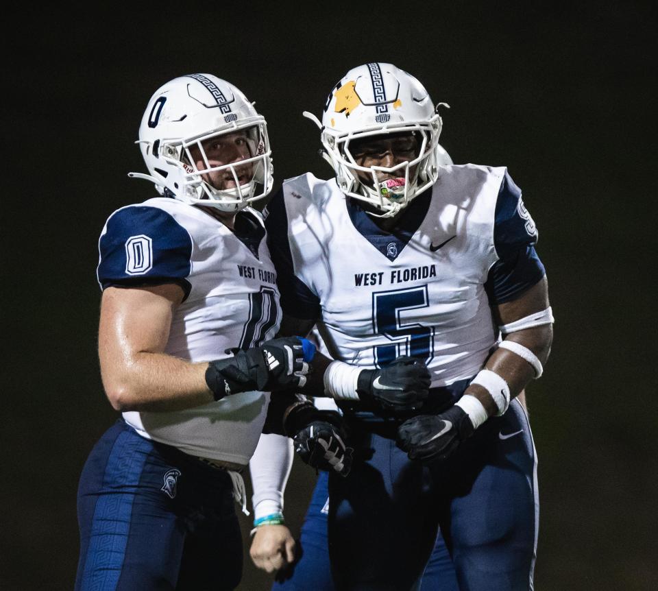 University of West Florida defensive linemen Jacob Dorn (0) and John McMullen (5) celebrate after a play during the Argos' victory at North Greenville University on Saturday, Sept. 30, 2023, in Tigerville, South Carolina.