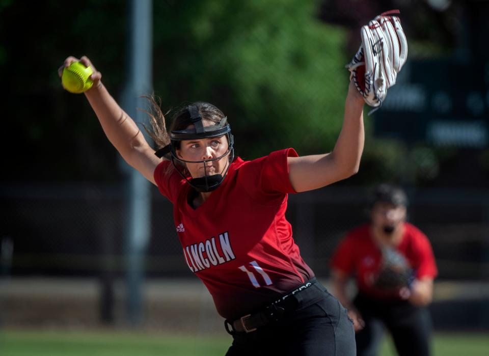 Lincoln's Peja Goold delivers a pitch during a girls varsity softball game against Tracy High at the Tracy Softball Complex on April 27, 2022.