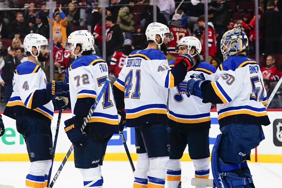 St. Louis Blues goaltender Jordan Binnington (50) and teammates celebrate the team's 5-3 win in an NHL hockey game against the New Jersey Devils on Thursday, Jan. 5, 2023, in Newark, N.J. (AP Photo/Frank Franklin II)