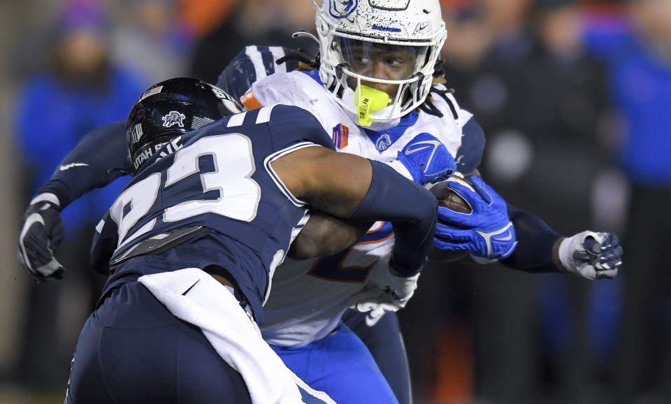 Utah State safety Devin Dye (23) tackles Boise State running back Ashton Jeanty in the first half of an NCAA college football game Saturday, Nov. 18, 2023, in Logan, Utah. | Eli Lucero/The Herald Journal via AP