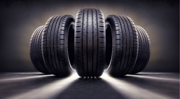 Five tires in a dark gray background