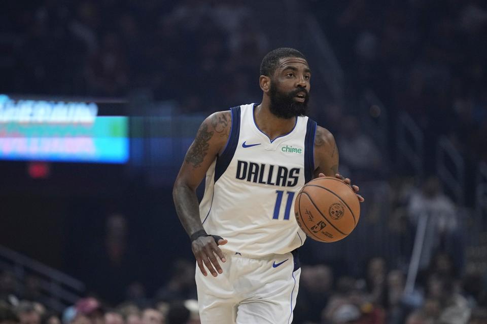 Mavericks guard Kyrie Irving (11) handles the basketball against the Cavaliers, Tuesday, Feb. 27, 2024, in Cleveland.