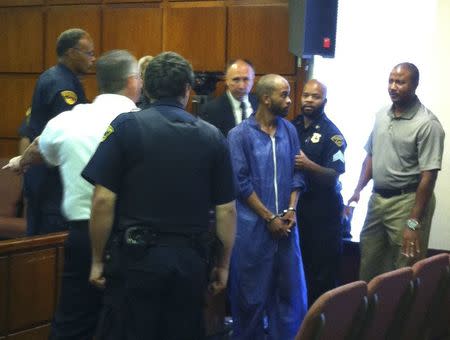 Michael Madison, handcuffed and wearing a gauzy purple jumpsuit, is pictured during an appearance in East Cleveland Municipal Court in East Cleveland, Ohio, July 22, 2013. REUTERS/Kim Palmer/Files