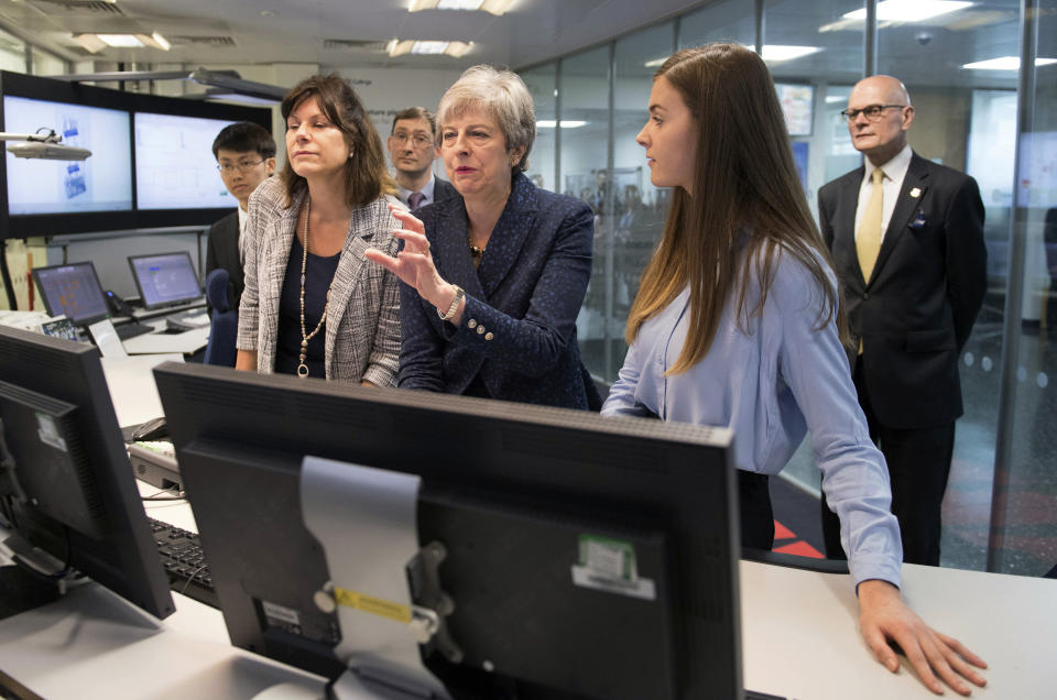 Britain's Prime Minister Theresa May during a visit to Imperial College where she saw machinery which converts carbon dioxide into oxygen, in London, Wednesday, June 12, 2019. Britain's outgoing prime minister on Wednesday announced plans to eliminate the country's net contribution to climate change by 2050 as Europe's effort to slow global warming picked up speed. (Stefan Rousseau/Pool photo via AP)