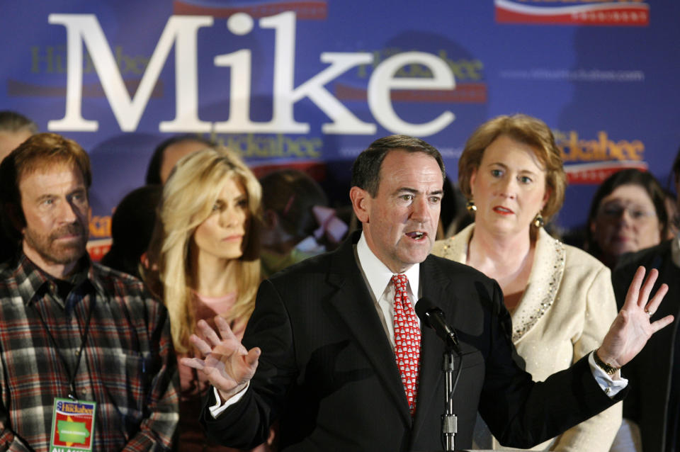 Mike Huckabee apparently on stage surrounded by supporters.