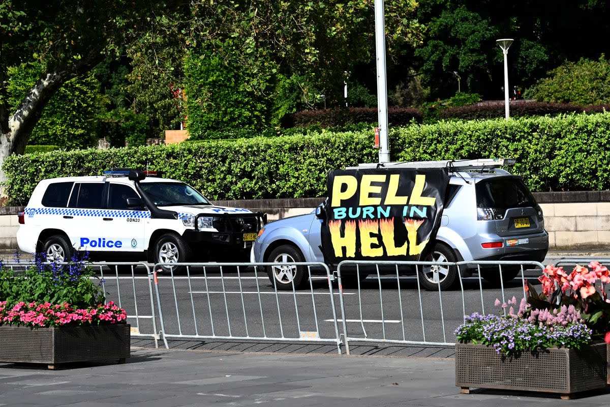 A car carrying a slogan saying ‘Pell Burn In Hell’ ahead of a pontifical requiem Mass for Cardinal George Pell at St Mary’s Cathedral in Sydney (REUTERS)