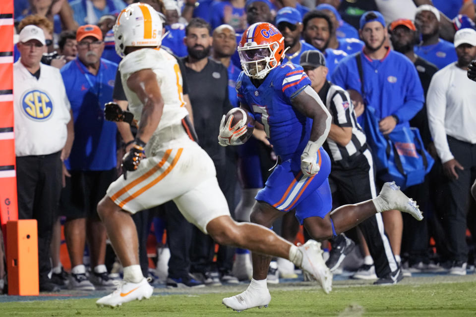 Florida running back Trevor Etienne (7) tries to get past Tennessee linebacker Aaron Beasley, left, during the second half of an NCAA college football game, Saturday, Sept. 16, 2023, in Gainesville, Fla. (AP Photo/John Raoux)