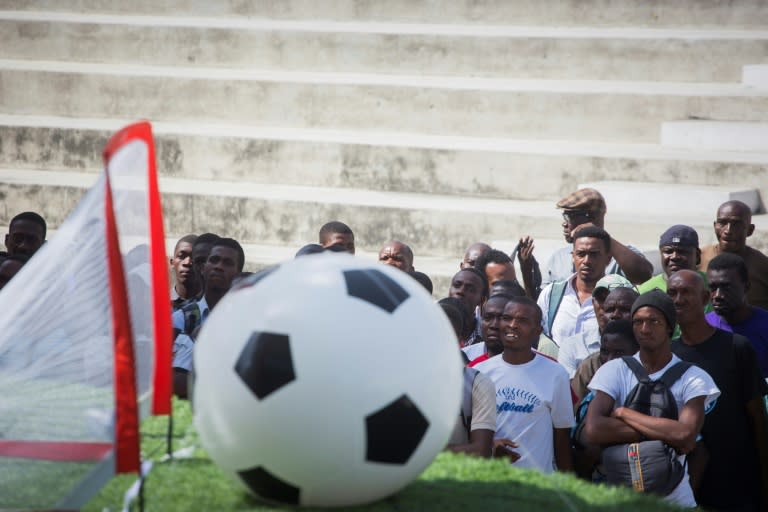 Inflatable balls, artificial turf and the flags of the World Cup teams have been installed around three big screens at the Champ de Mars, the main public square in Port-au-Prince