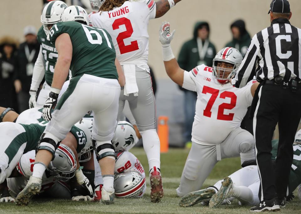 FILE - In this Saturday, Nov. 10, 2018, file photo, Ohio State defensive tackle Tommy Togiai (72) reacts after teammate defensive tackle Dre'Mont Jones (86) recovers a fumble at the 2-yard line during the second half of an NCAA college football game, in East Lansing, Mich. A strong connection between law enforcement and Idaho State student-athletes, including Togiai, set the stage for peaceful unity march on June 3, 2020, in Pocatello, Idaho. (AP Photo/Carlos Osorio, File)